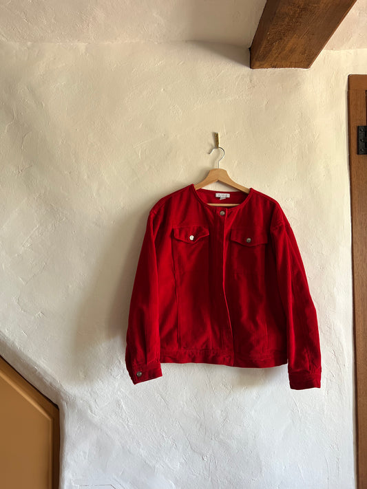 Aligne Red Cord Moto Jacket hanging against a white wall 