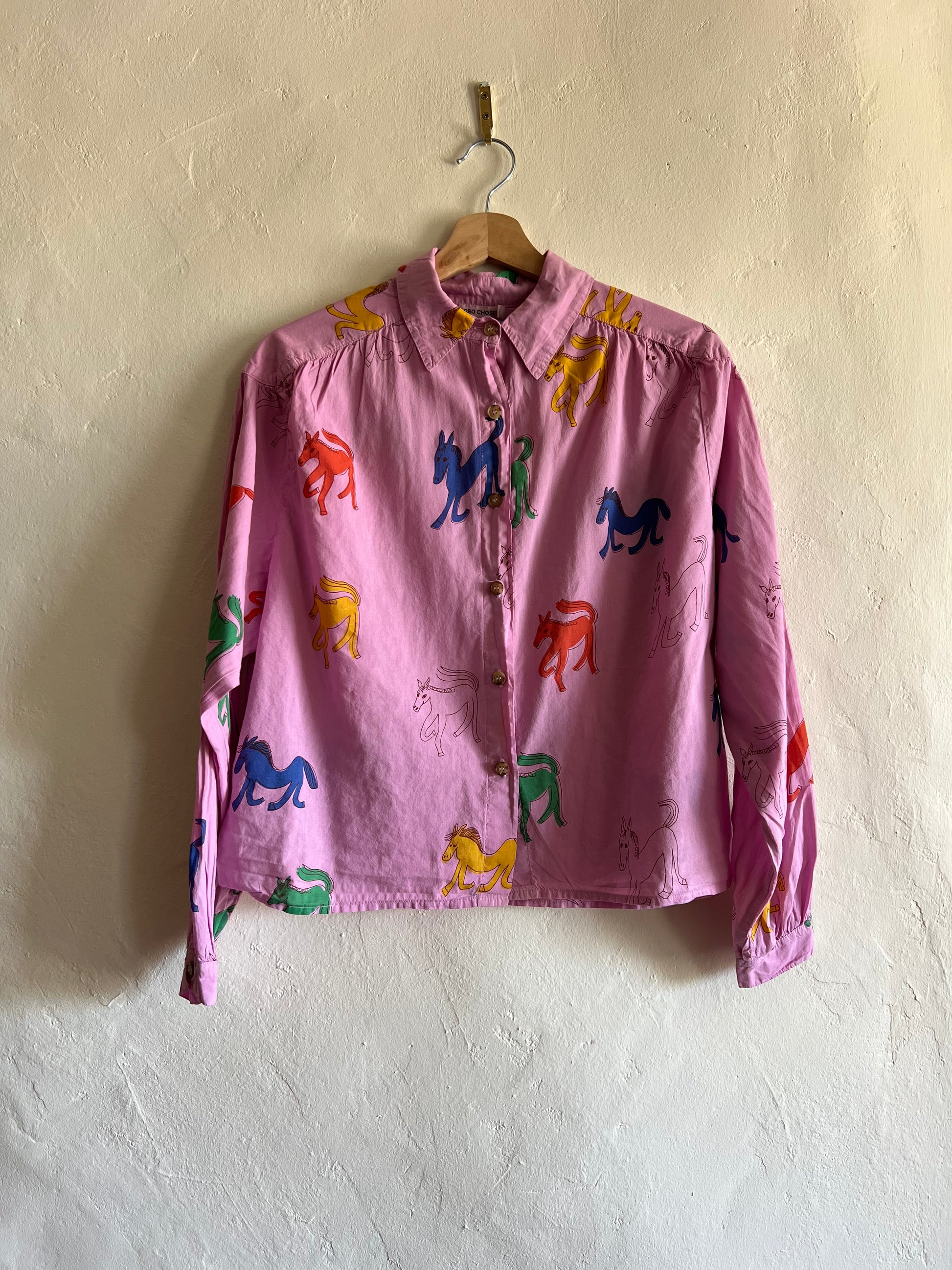 Bobo Choses Pink Wonder Horse Shirt on hung against a white wall 