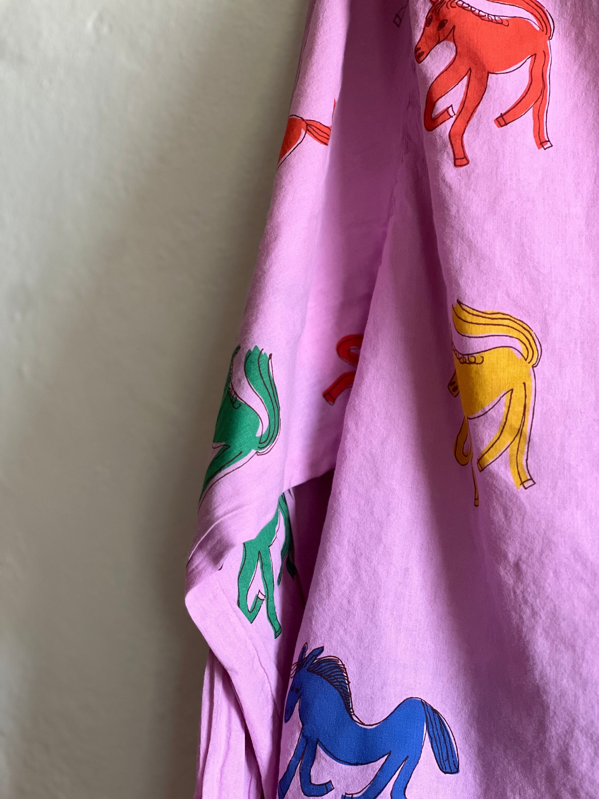 Bobo Choses Pink Wonder Horse Shirt on hung against a white wall 