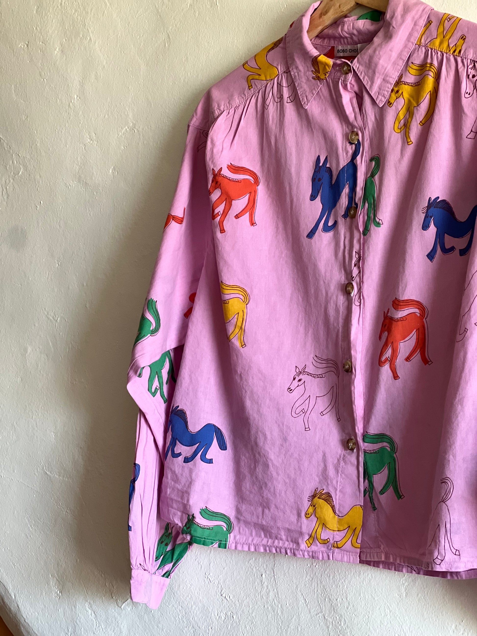 Bobo Choses Pink Wonder Horse Shirt on hung against a white wall 