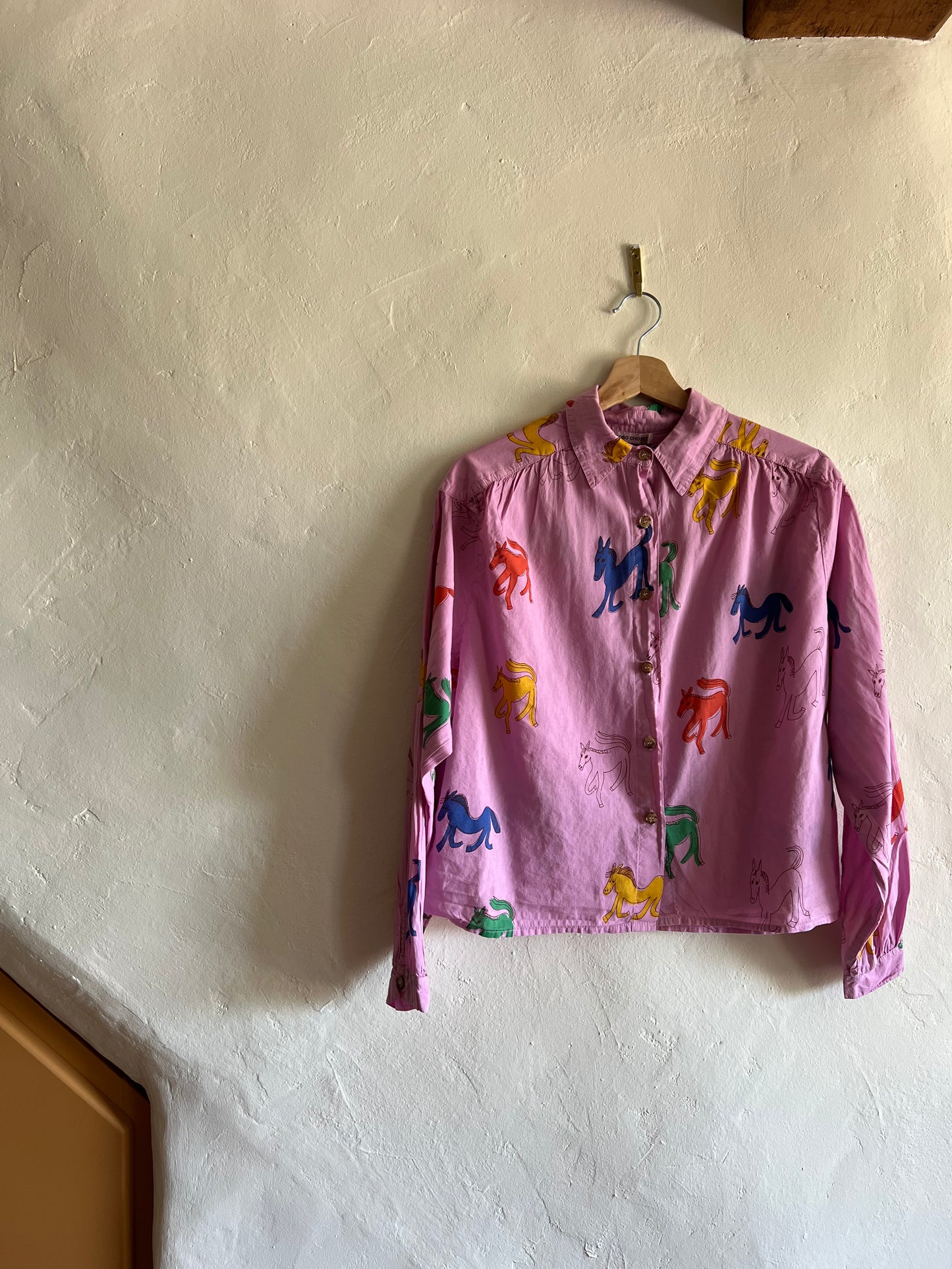 Bobo Choses Pink Wonder Horse Shirt on hung against a white wall 