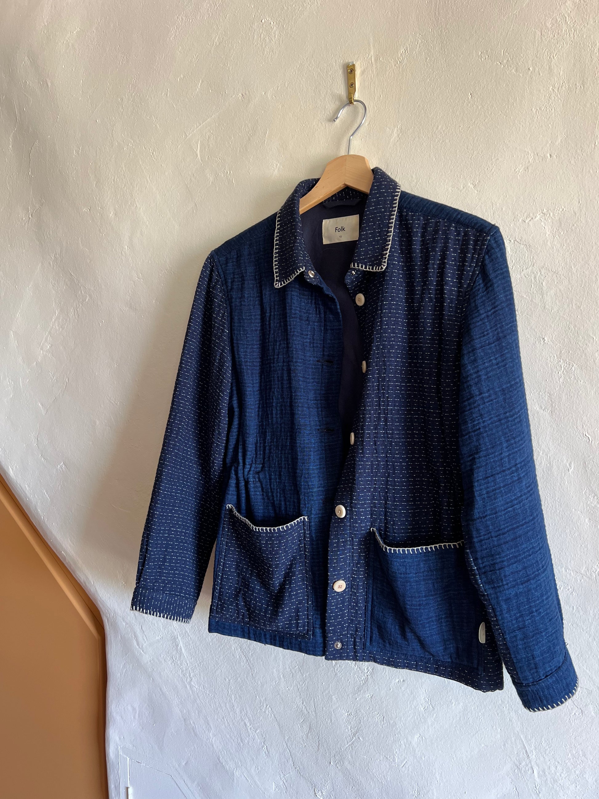 Folk Indigo Sashiko Waffle Patch Jacket hug against a wall 