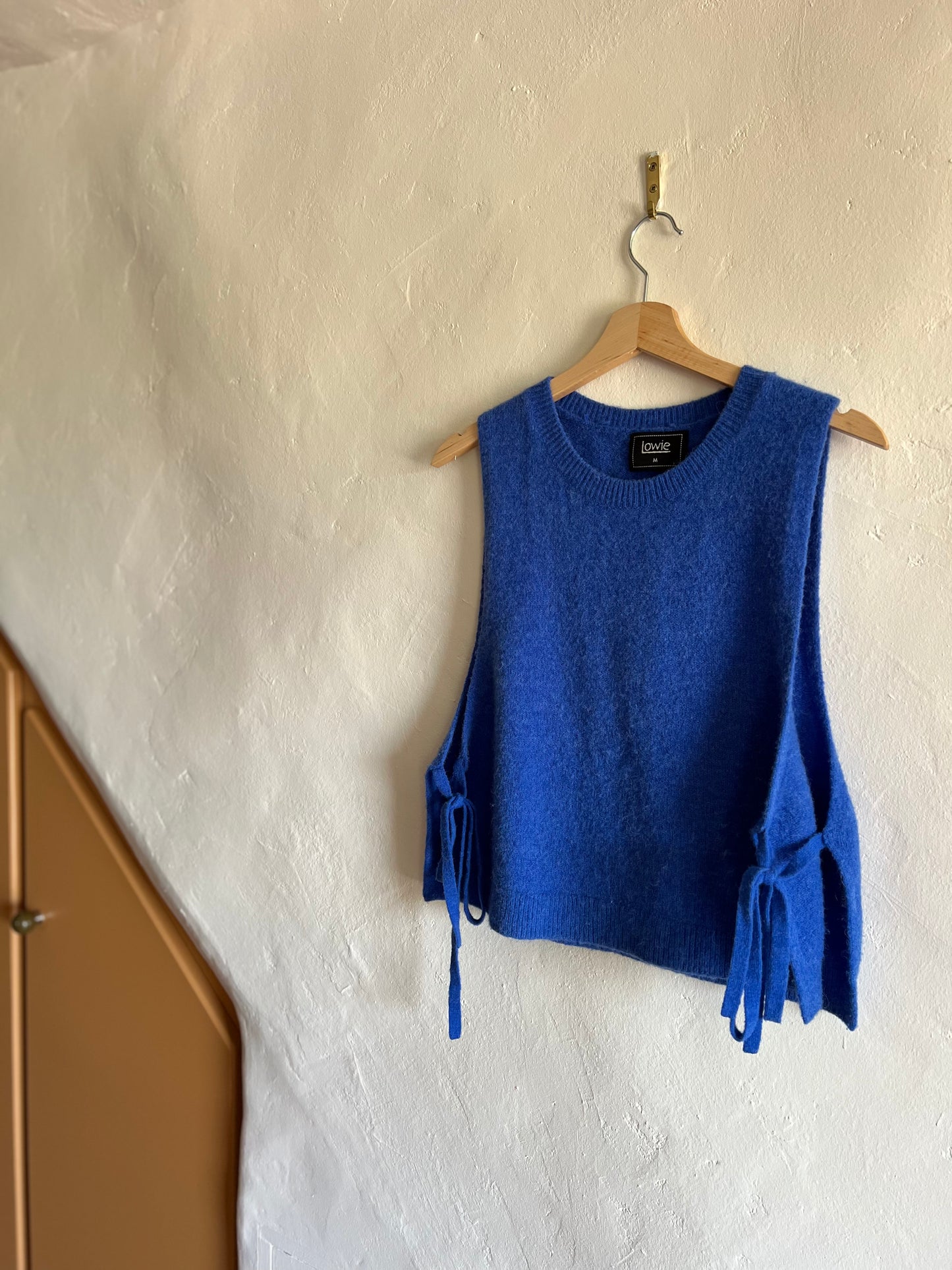 Lowie Colbalt Sleeveless Knit Vest against a white wall 