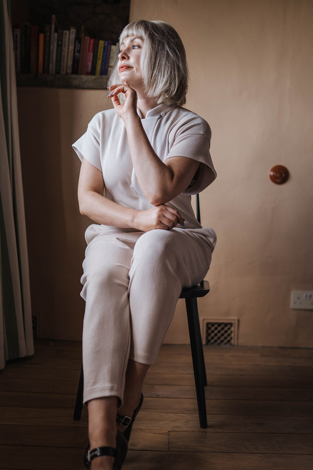 MEG Off-White Crepe Jumpsuit worn on seated model 