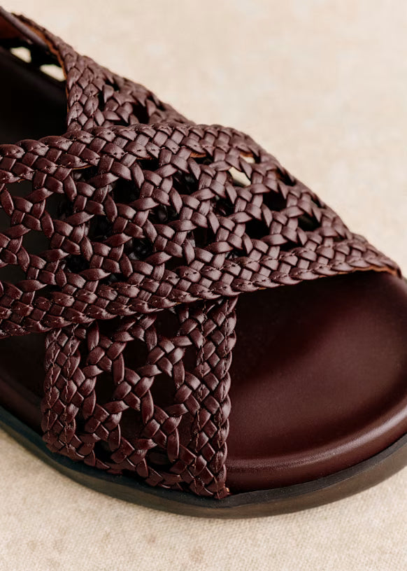 Brown woven sandal on a beige background