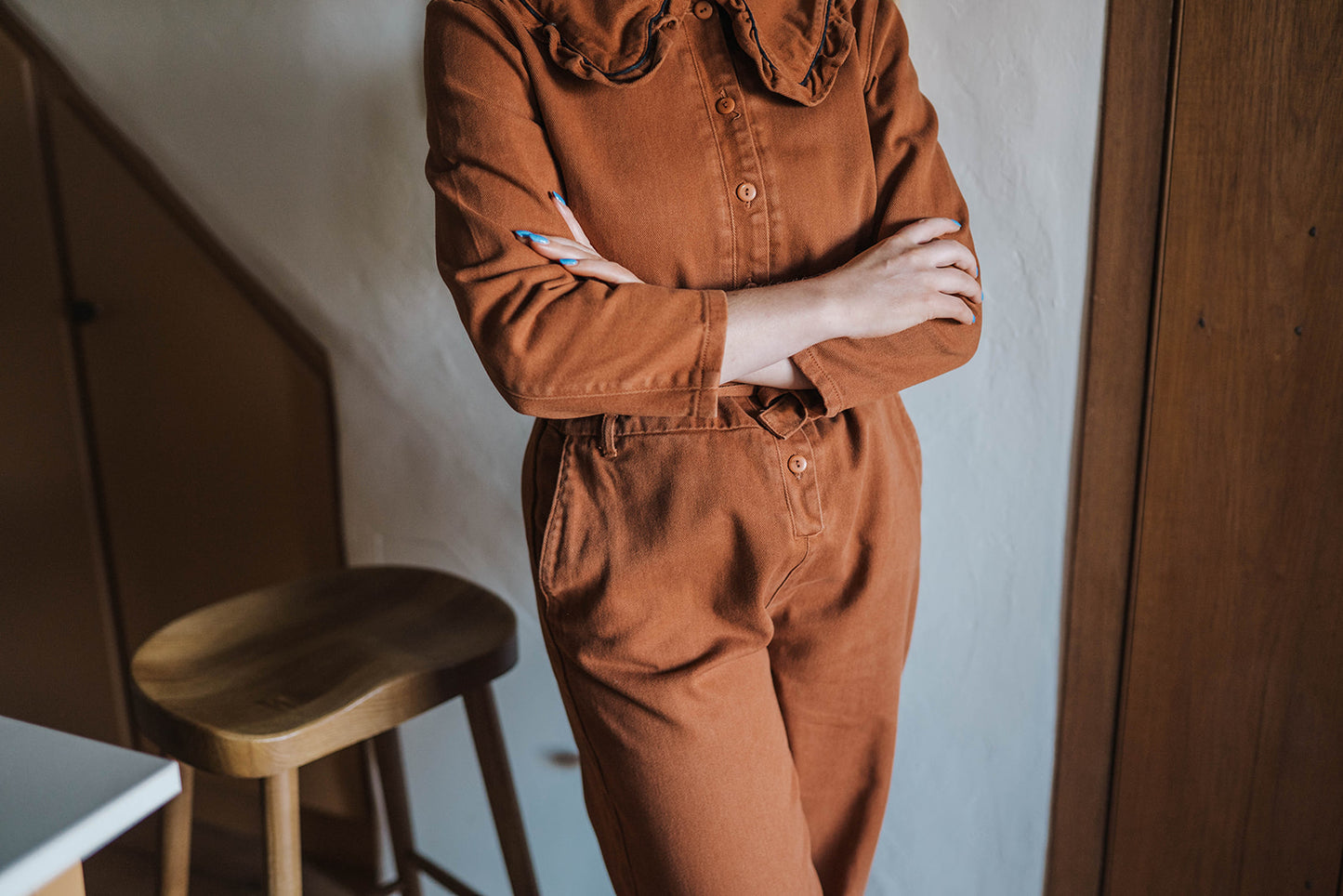 The Tiny Big Sister Rust Oversize Ruffle Collar Jumpsuit worn on model 